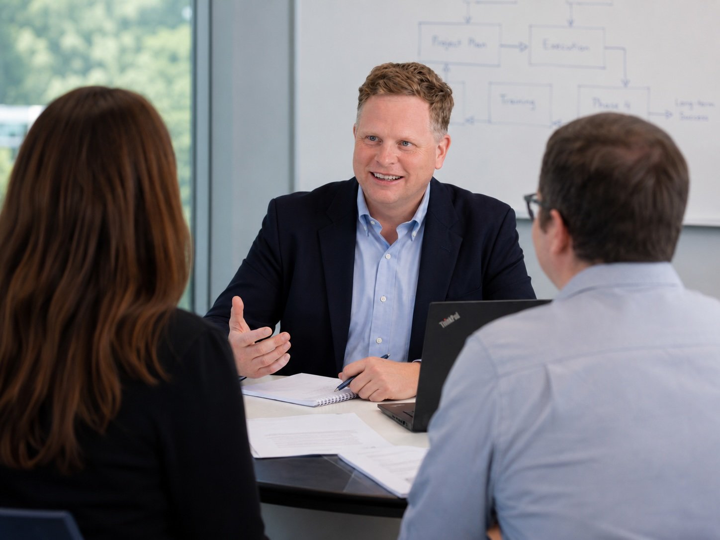 mark lindsey planning with people at desk